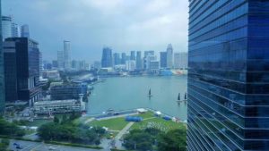 Singapore's marina with boats, on a cloudy day, viewed from a skyscraper.